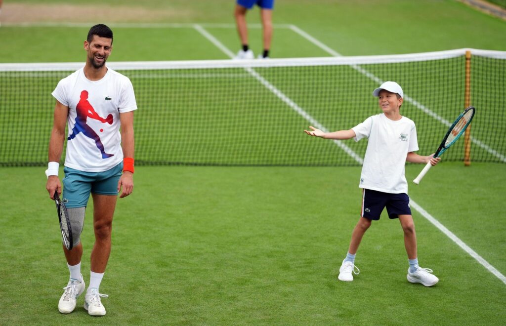 Novak Djokovic with his son Stefan, on day ten of the 2024 Wimbledon Championships at the All England Lawn Tennis and Croquet Club, London. Picture date: Wednesday July 10, 2024.