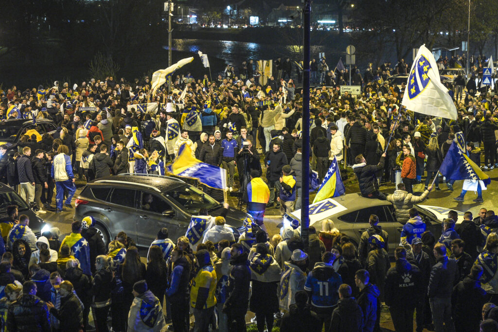 People celebrate on the streets after Bosnia and Herzegovina qualified for the FIFA World Cup